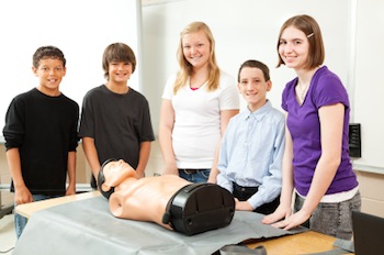 Students learn CPR with a dummy